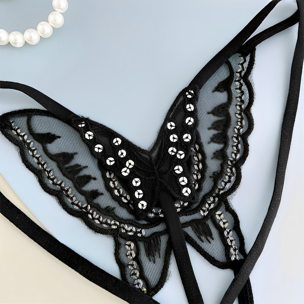 Calcinha preta com desenho de borboleta em renda e detalhes brilhantes, detalhe da renda